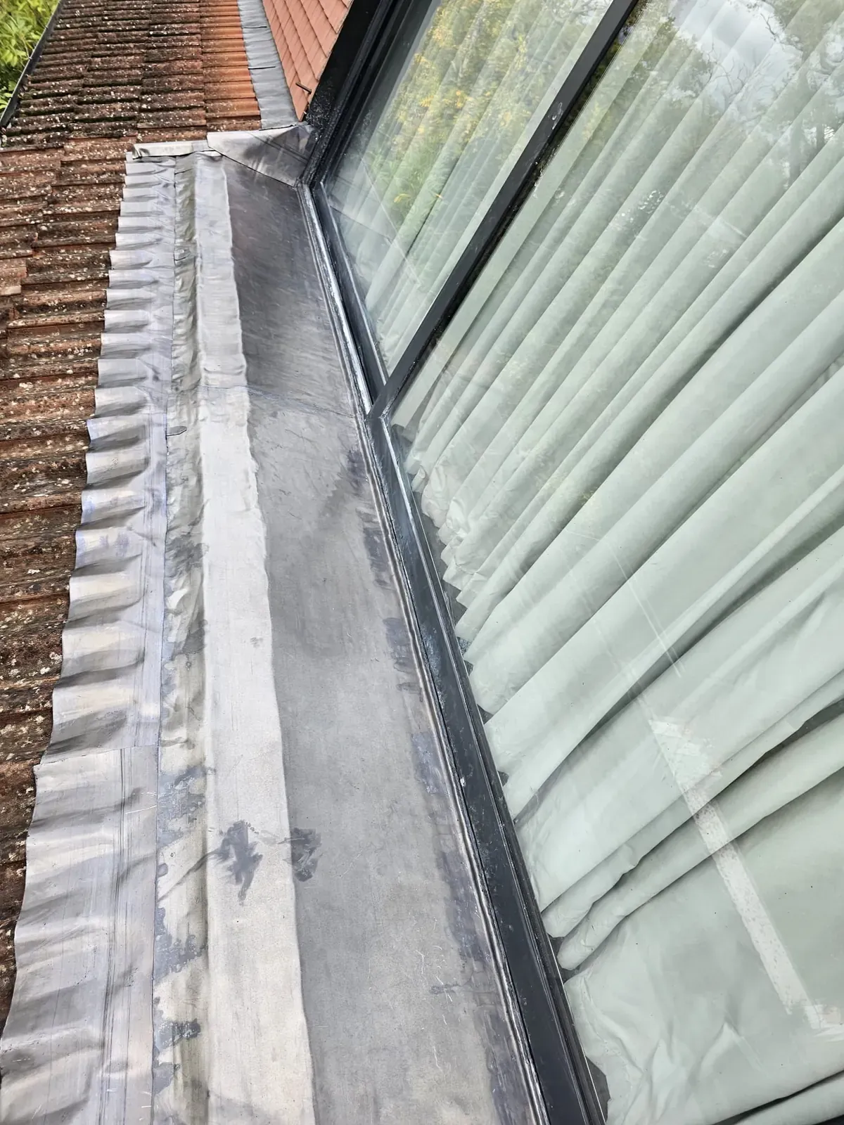 Lead flashing dressed neatly beside a dormer window